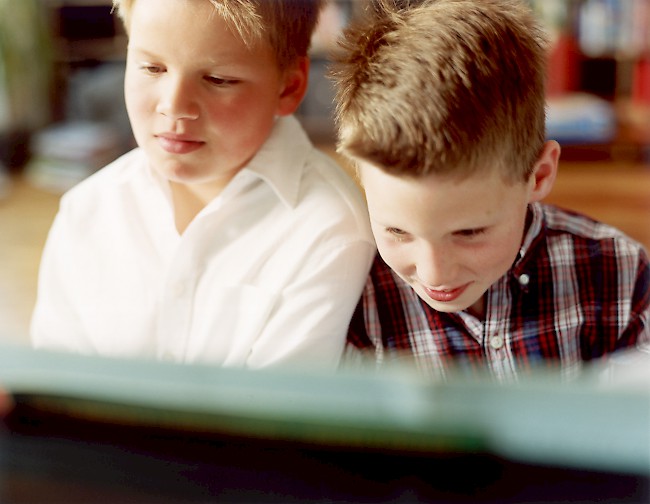 Two boys playing piano